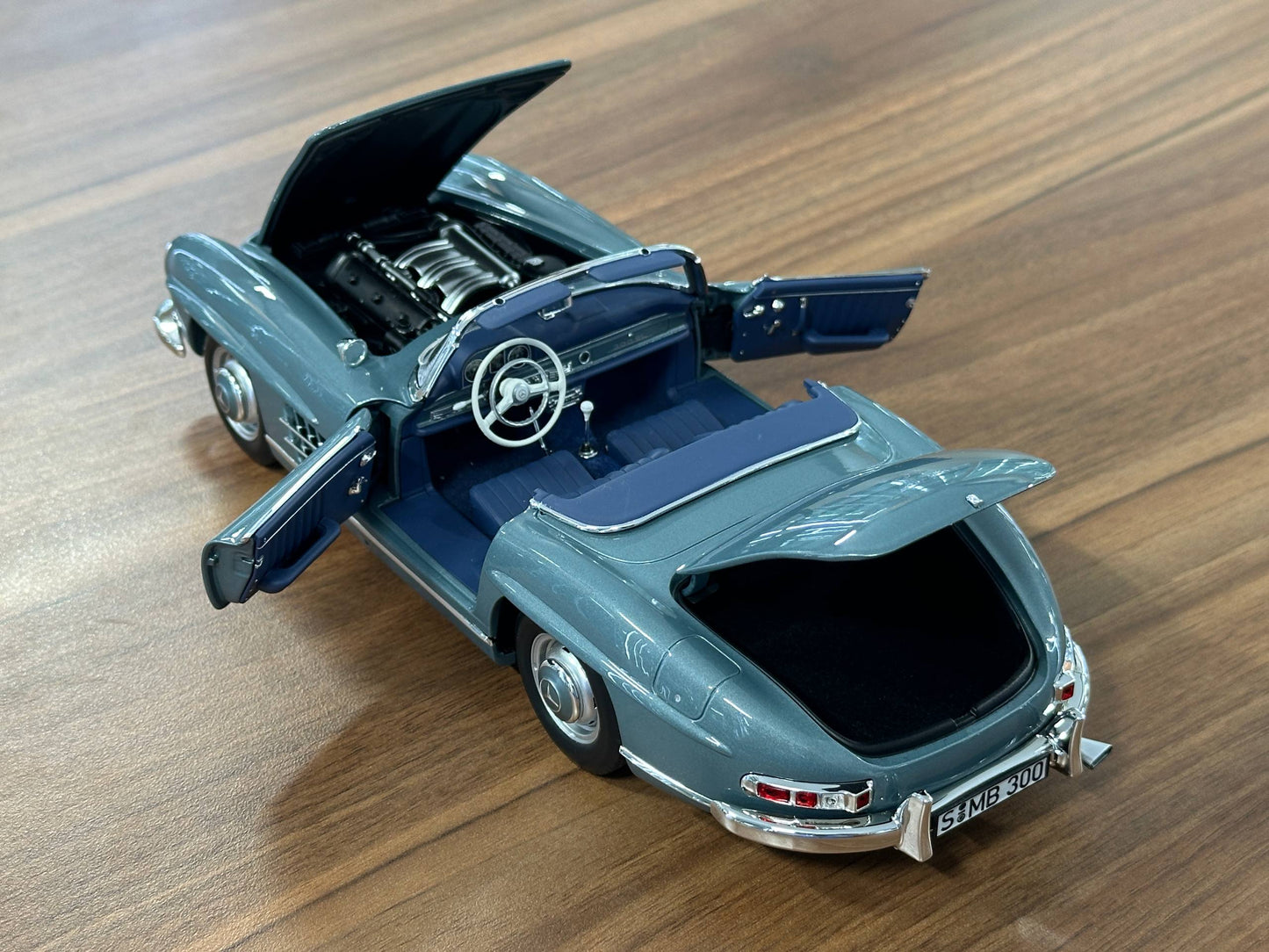 1/18 Diecast Mercedes-Benz 300 SL Roadster (W198, 1957–1963) – Norev Dealer Edition (Light Blue, Full Opening)